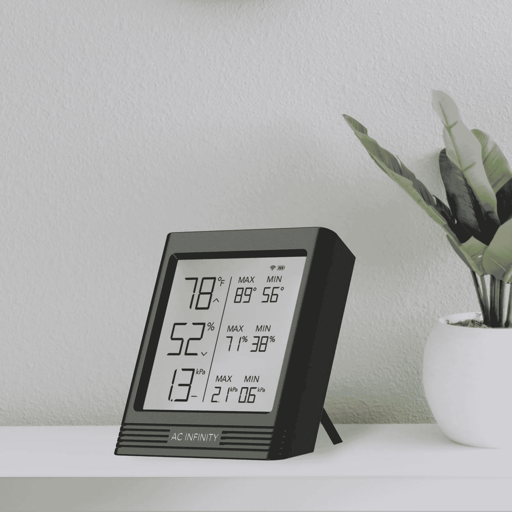 AC Infinity CLOUDCOM B concept art — backlit Bluetooth hygrometer in grow tent