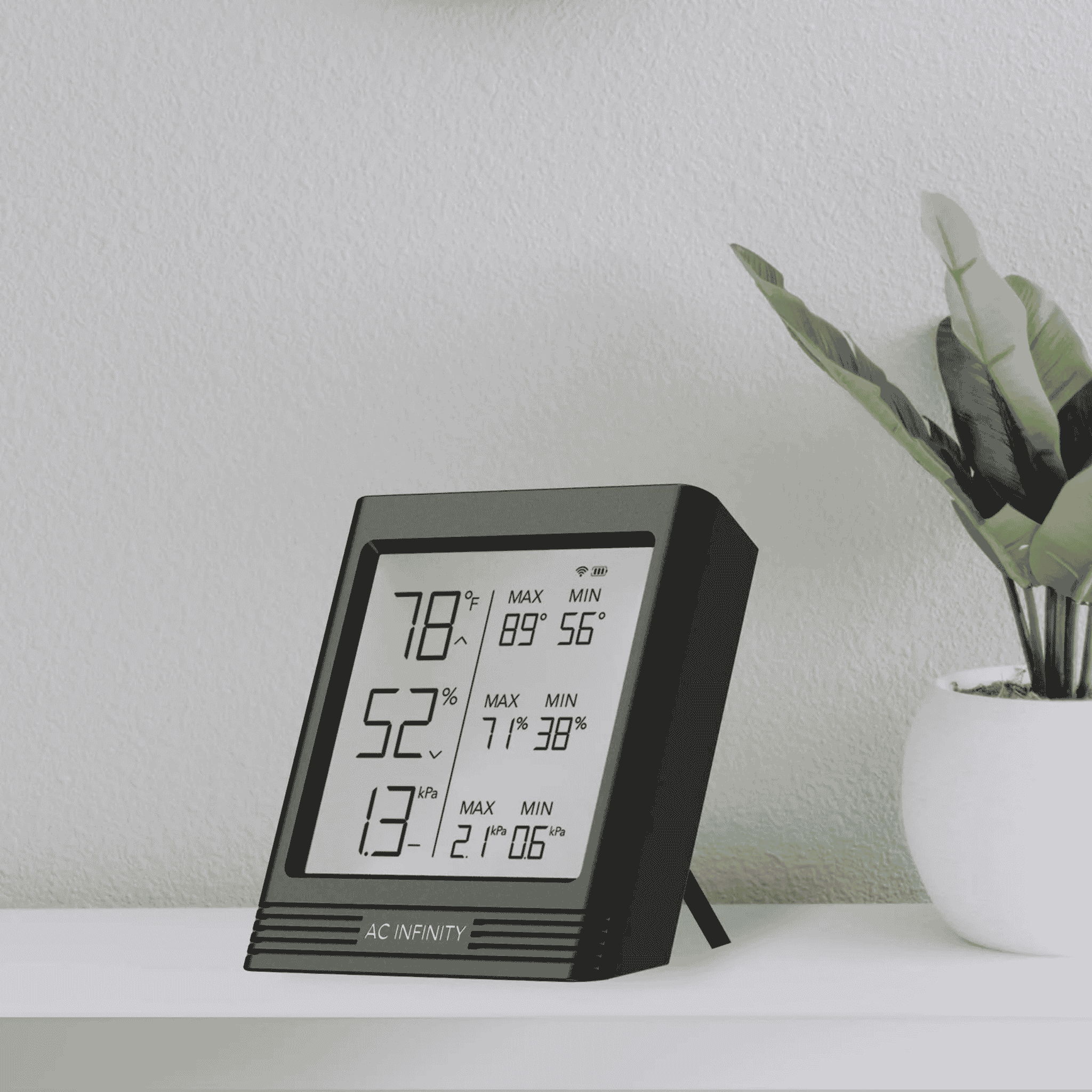 AC Infinity CLOUDCOM B concept art — backlit Bluetooth hygrometer in grow tent